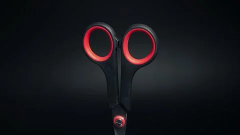 Scissors with red handles on a black background rotate close-up Stock Footage 291955748