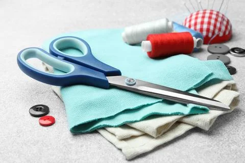 Scissors, spools of threads and sewing tools on white background Stock Photos
