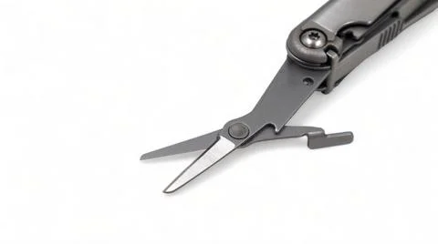 The scissors tool is pulled out of the multitool. Modern steel multitool with Stock Photos