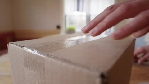 Scissors used to open a parcel received from an online order. Close up Stock Footage 277576688