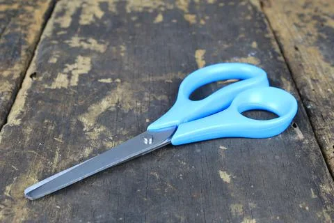 Scissors on wood background Stock Photos