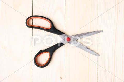 Scissors on wooden background Stock Photos