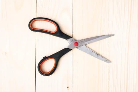 Scissors on wooden background Stock Photos