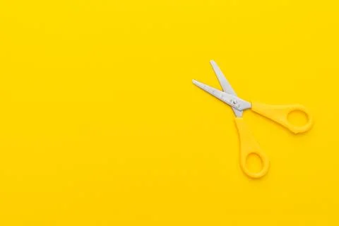 Scissors on yellow back Stock Photos