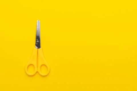 Scissors on yellow back Stock Photos