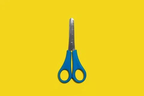 Scissors on a yellow background Stock Photos