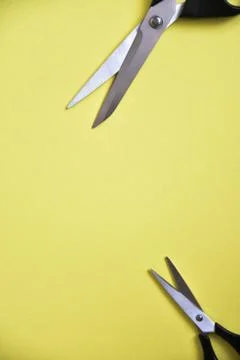 Scissors on yellow background Stock Photos