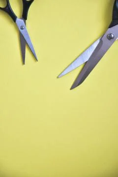 Scissors on yellow background Stock Photos