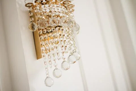 Sconce on the wall with crystal elements. Golden sconce. Stock Photos
