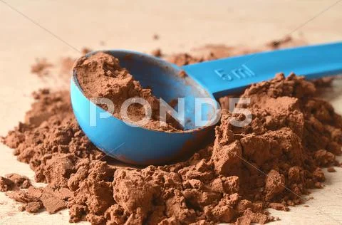 Scoop in brown powder Stock Photos