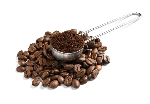 Scoop with coffee grounds and roasted beans on white background Stock Photos