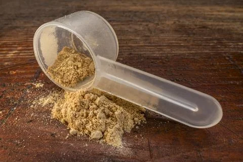 Scoop of maca root  powder Stock Photos