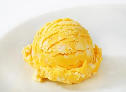 Scoop of pineapple or mango ice cream Stock Photos