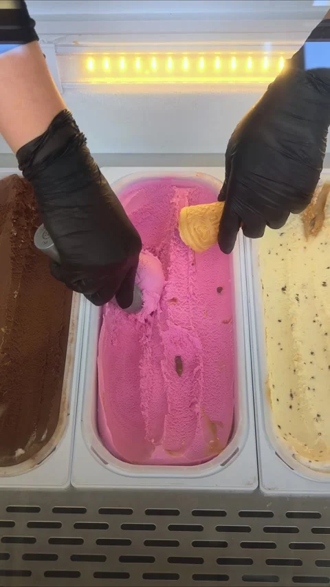 Scoop portion of ice cream from container with spoon. Stock Footage 310982943