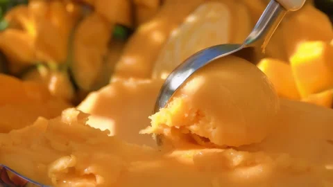 Scoop of Refreshing Mango Sorbet Video stock 336078360