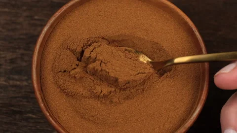 Scoop with spoon Cinnamon powder, close up Stock Footage 340193700