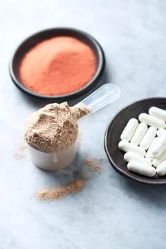 Scoop of Whey Protein, Beta-alanine capsules and Creatine Powder. Stock Photos