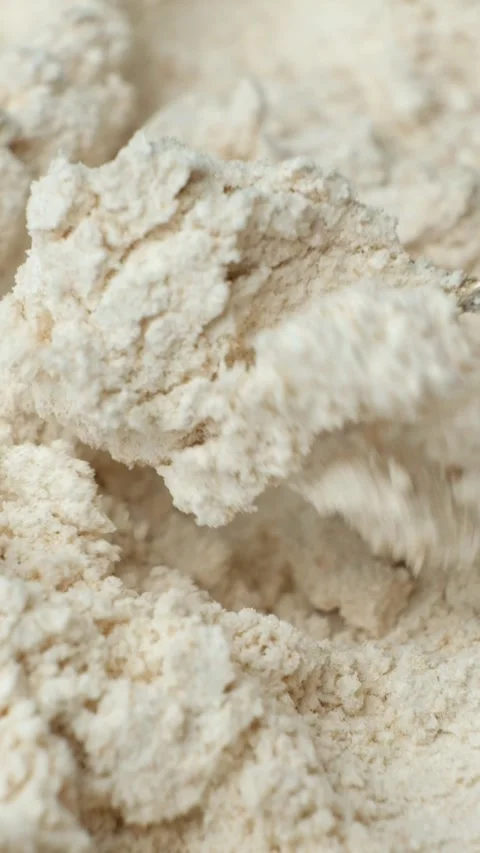 Scooping and pouring organic spelt flour with spoon slow motion vertical view Stock Footage 346760236