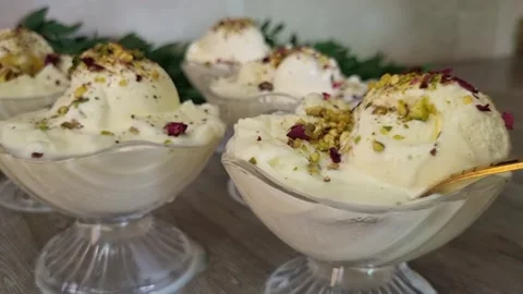 Scooping Arabic Booza Ice Cream with Pistachio and Rose | Dessert Glass Bowls Stock Footage 344792592