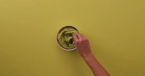 Scooping up avocado hummus with a chip 1 Video stock 132208028