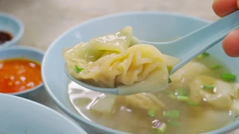 Scooping Chinese dumpling in dumpling soup Stock Footage 300777310