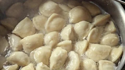 Scooping Cooked Dumplings from Hot Water with a Slotted Spoon Stock Footage 345453934