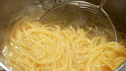 Scooping Cooked Spaghetti From Boiling Water Pot Video stock 345600249