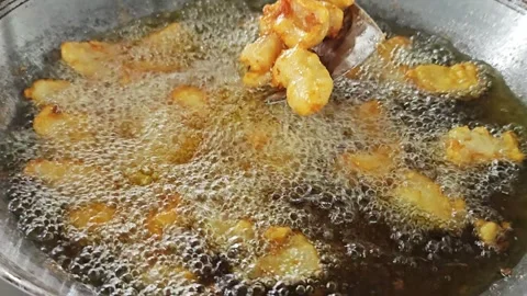 Scooping crispy fried fish with a metal spatula from a wok. Stock Footage 342738088