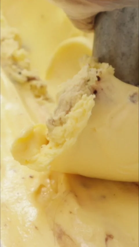 Scooping delicious biscuit cream ice cream in tub, vertical video Stock Footage 340528032