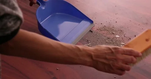 Scooping dirt into a dustpan 5 Stock Footage 132220431