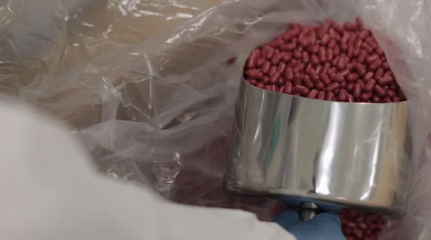 Scooping Up Empty Red Pill Capsules Stock Footage 67888362