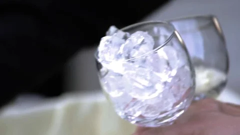 Scooping ice into two glasses, in slow motion Stock Footage 78108451