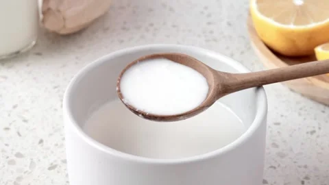 Scooping instant buttermilk into a wooden spoon Stock Footage