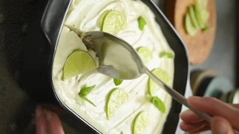 Scooping lime pie with a spoon from the tray. Vertical video. Stock Footage 311046101