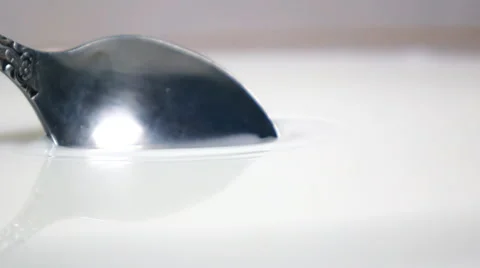 Scooping up milk with spoon Stock Footage 62650307