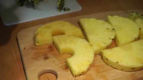 Scooping out the center of pineapple slices  Stock Footage 168142676