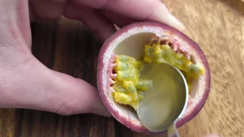 Scooping Passion Fruit Pulp with Spoon  Close-Up Tropical Fruit Preparation Stock-Footage 330136207