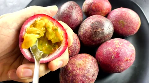 Scooping passion fruit by a spoon  , in door Chiangmai Thailand. Stock Footage 303206399