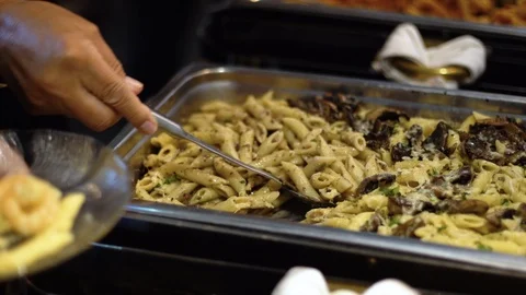 Scooping up pasta onto an appetizer plate Stock Footage 87296089
