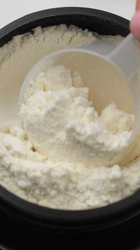 Scooping Protein Powder jar for making protein cocktail Video stock 301394645