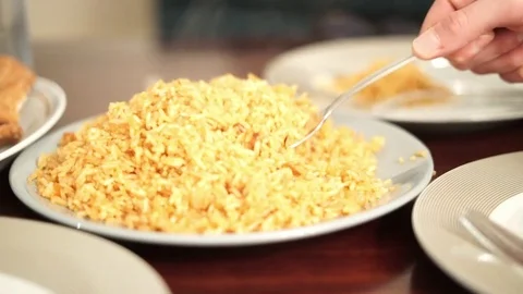 Scooping up rice on a plate Stock Footage 75352174