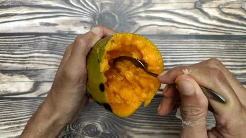 Scooping Ripe Fresh Mango Stock Footage 322007476