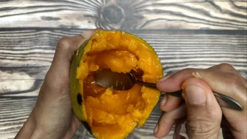 Scooping Ripe Fresh Mango Stock Footage 322007479