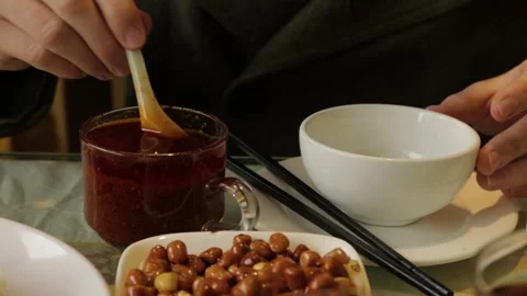 Scooping Sauce at Dining Table with Peanuts and Chopsticks in Beijing Restaurant Stock Footage 345745223