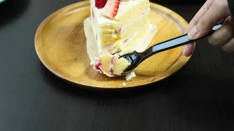 Scooping Strawberry Shortcake Slice with Spoon on Wooden Plate Stock Footage 318509238