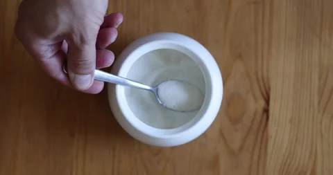 Scooping Sugar with Stainless Steel Teaspoon Top View Slow Motion Stock Footage 340849366