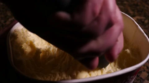 Scooping vanilla ice cream from container close up on man hand Stock Footage 150918953