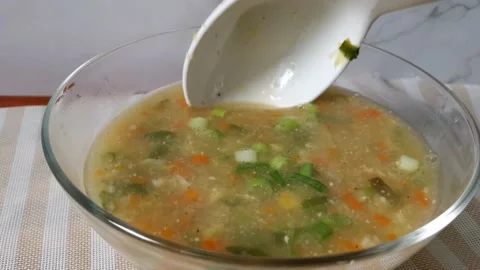 Scooping Vegetable Corn Soup in a Glass Bowl Stock Footage 236774327