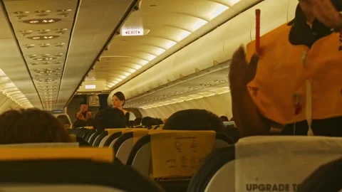 Scoot airlines cabin crew performing a standard gesture of pre-flight safety on Stock Footage 335272275