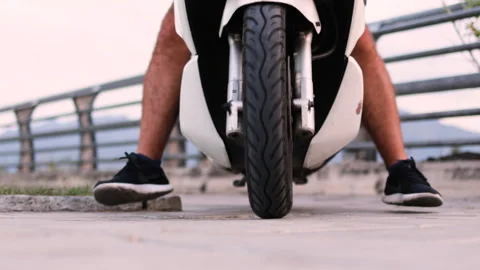 Scooter approaches the camera, its front wheel visible. Stock Footage 312639022